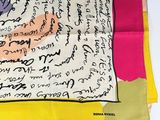 a picture of a colorful scarf with writing on it