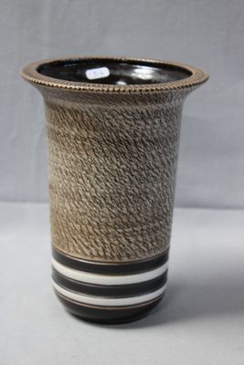 a black and white vase with a rope wrapped around it