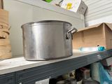 pots and pans are on a shelf in a kitchen