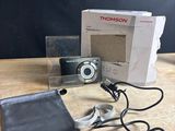 the camera is sitting on the table next to the box