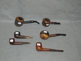 several different types of pipe sitting on top of a gray surface