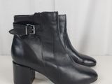 a pair of black leather ankle boots with buckles