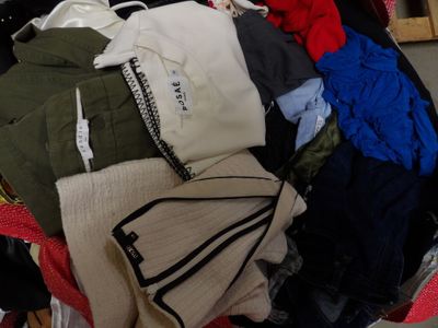 a pile of clothes that is sitting in a suitcase