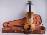 a violin sitting in a case on the wall