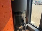 a black and silver trash can sitting in front of a window