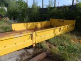 a yellow truck bed sitting in the middle of a field