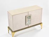 a white cabinet with gold legs and a mirror on the door