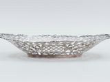 a silver plate with a flower design on it