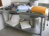 a metal table with a pot on top of it