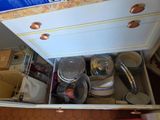 a drawer full of pots and pans in a kitchen