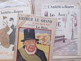 many books on the table with pictures of people on them