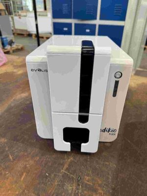 an image of a white machine sitting on top of a wooden table