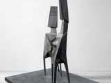 an image of a sculpture of a chair on a table