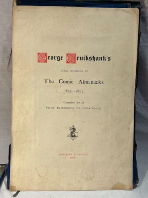an old book sitting on top of a table next to a white cloth