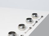 four silver bowls and spoons sitting on a white surface