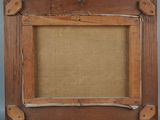 an old picture frame with a picture hanging on a wall