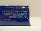 a blue plaque with a picture of a person holding a cell phone