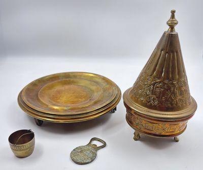 several pieces of brass are sitting on a white surface