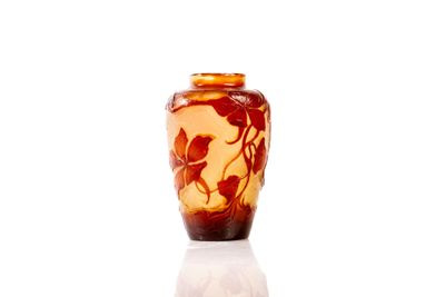 a vase with a bird design on it on a white surface