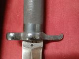 a close up of a knife on a red cloth