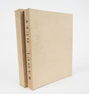 a brown book with a black writing on it sitting on top of a white surface