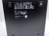 the back of a black laptop with a battery on top of it