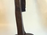 a wooden sculpture of a boat on a stand