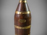 an image of a wooden wine bottle with brass trims