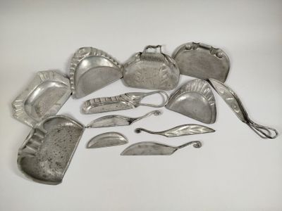 a lot of silverware on a white surface
