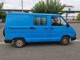a blue van that is parked in a parking lot