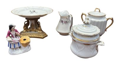 three different types of porcelain teapots and a cake plate