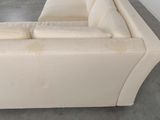 a white couch that is sitting on a concrete floor