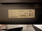 a laptop that is sitting on a table with a label on it