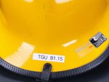 a yellow hard hat sitting on top of a black table