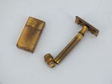 two antique brass shavings and a lighter on a white surface