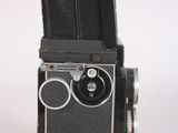 a black and white photo of a camera on a table