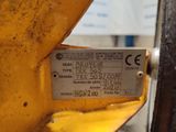 a label on the side of a machine that is sitting on the ground