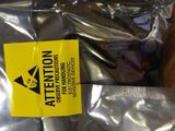 a bag of silver foil sitting on a wooden table