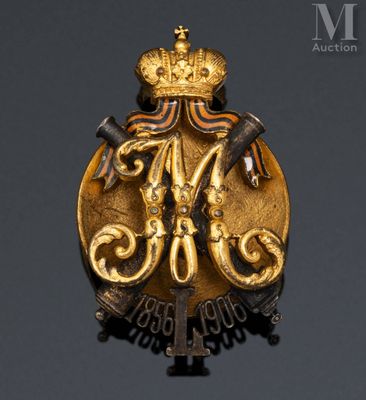 a close up of a gold badge with a crown on it