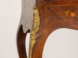 a small wooden table with a bird on top of it