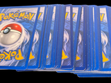 a lot of pokemon cards sitting on top of each other