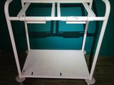 a white cart with a handle on it in a room