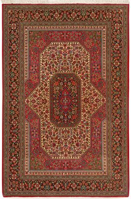 a red and green rug with a medallion design