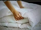 a person that is laying on a bed with a pillow