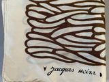 a white towel with a brown design on it