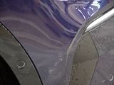 a close up of a car ' s front fender with the door handle missing