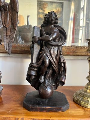 a statue of a man holding a sword on a table