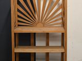 a wooden bench with a shelf in front of a black and white wall