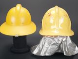 two yellow hard hats sitting next to each other on a black surface