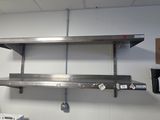 a metal shelf that is hanging on the wall